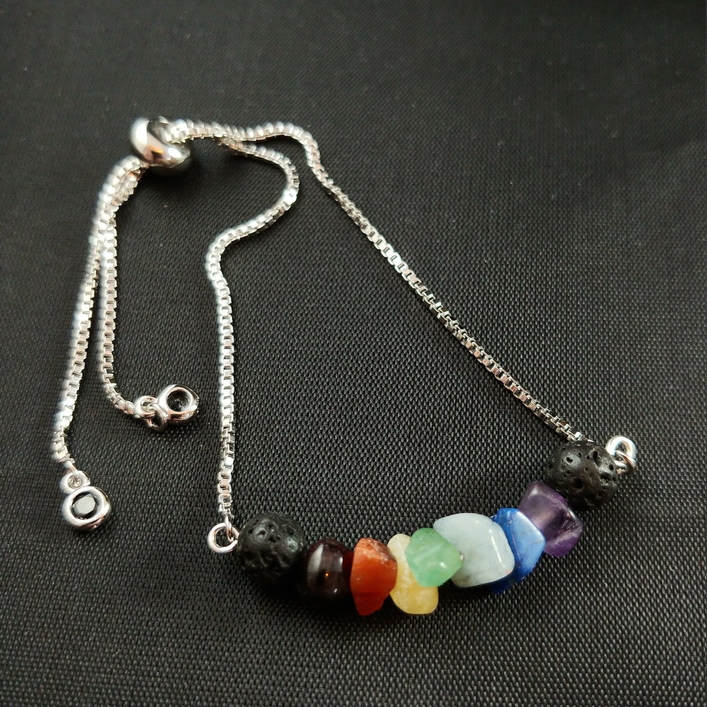 Adjustable silver brass bracelet with lava rocks and a mix of colorful gemstone chips