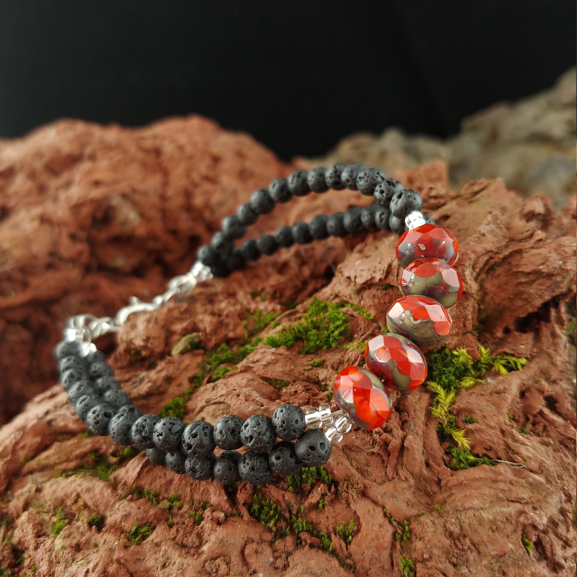 Bracelet with two rows of 4mm small lava stones and in the center is a single row of red polished terra cotta beads.